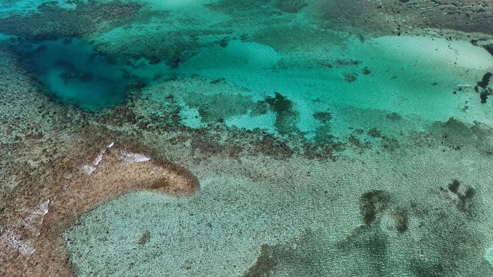 Stunning aerial shot of Bacalar Lagoon showcasing vibrant turquoise waters in Quintana Roo, Mexico.
